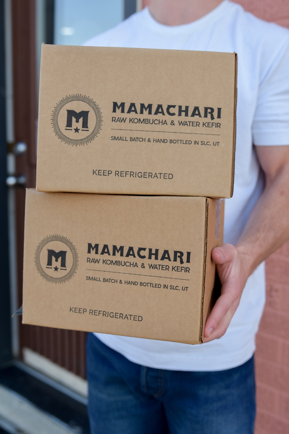 Mamachari delivery boxes being carried outside the shop